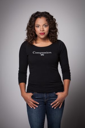 Woman wearing Compassion Boat Neck Shirt