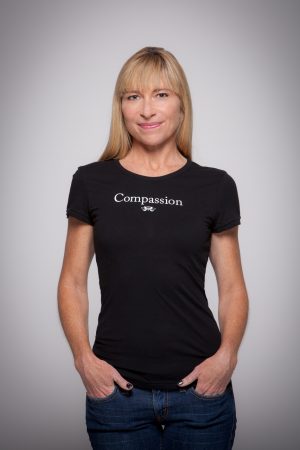 Woman wearing Compassion Cap Sleeve Tee