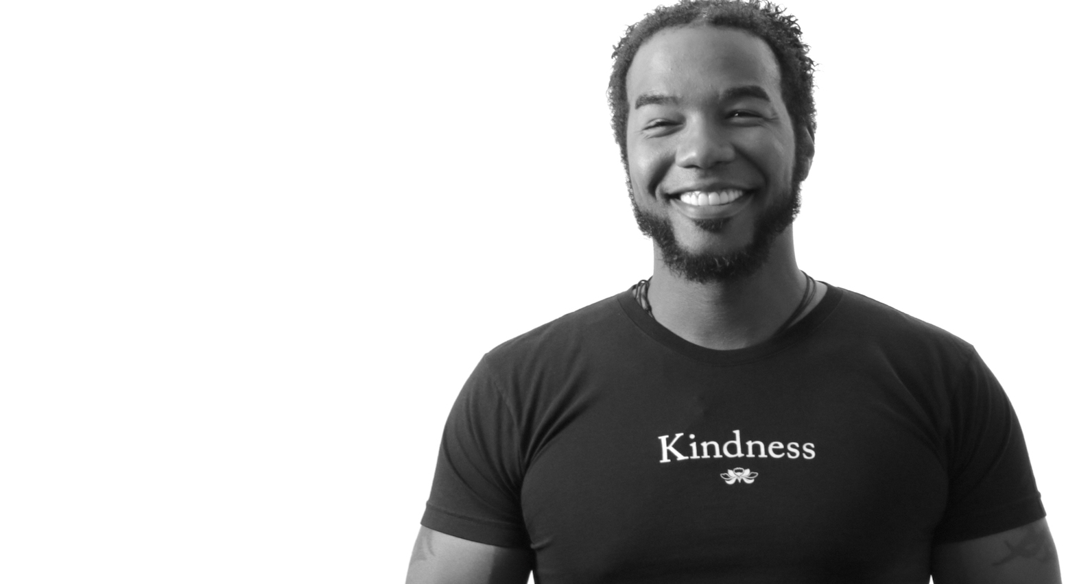 Man wearing black Kindness t-shirt